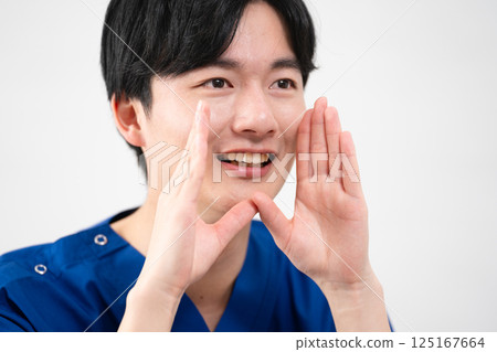 A young man wearing medical scrubs A young man wearing medical scrubs 125167664