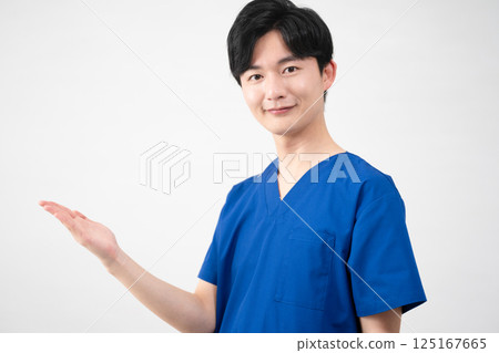 A young man wearing medical scrubs A young man wearing medical scrubs 125167665
