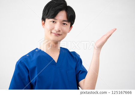 A young man wearing medical scrubs A young man wearing medical scrubs 125167666