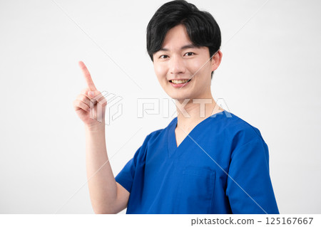 A young man wearing medical scrubs A young man wearing medical scrubs 125167667