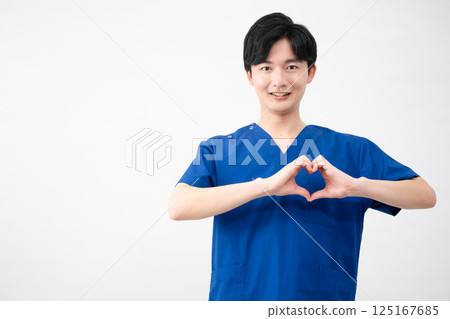 A young man wearing medical scrubs A young man wearing medical scrubs 125167685