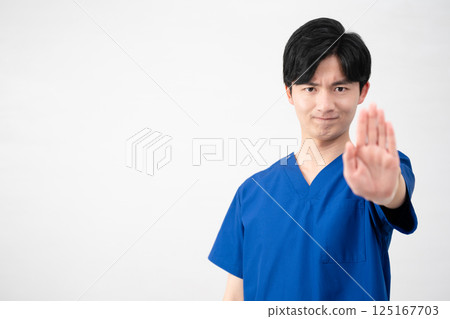 A young man wearing medical scrubs A young man wearing medical scrubs 125167703