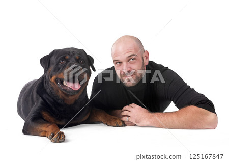 rottweiler and man in studio 125167847
