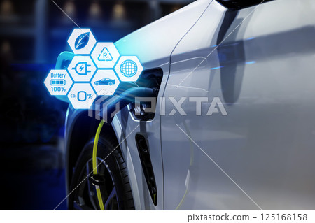 Power cable pump plug in charging power to electric vehicle EV car. Power cable pump plug in charging power to electric vehicle EV car. 125168158