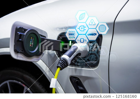 Power cable pump plug in charging power to electric vehicle EV car. Power cable pump plug in charging power to electric vehicle EV car. 125168160