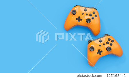 Realistic blue yellow video game joysticks or gamepads on blue background 125168441