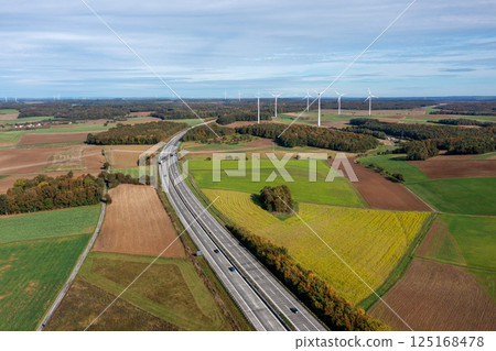 Aerial shot with german highway and wind turbines in autumn scenery 125168478