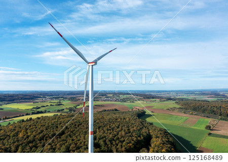 Drone aerial view of a single wind turbine in autumn scenery 125168489