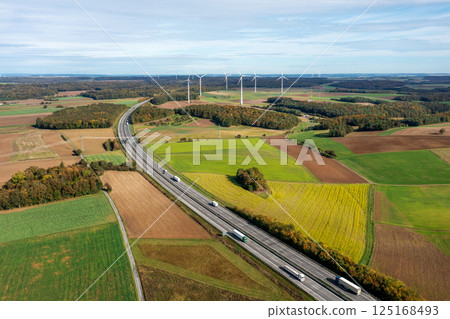 Drone shot with german highway and wind turbines in autumn scenery Drone shot with german highway and wind turbines in autumn scenery 125168493