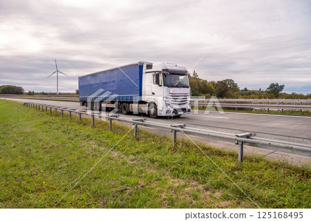 Truck driving on a German highway in the Baden Wurttemberg region Truck driving on a German highway in the Baden Wurttemberg region 125168495