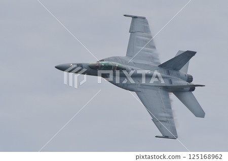 A US Navy F/A-18F Super Hornet performing a demonstration flight at the Iwakuni Air Base Air Show A US Navy F/A-18F Super Hornet performing a demonstration flight at the Iwakuni Air Base Air Show 125168962