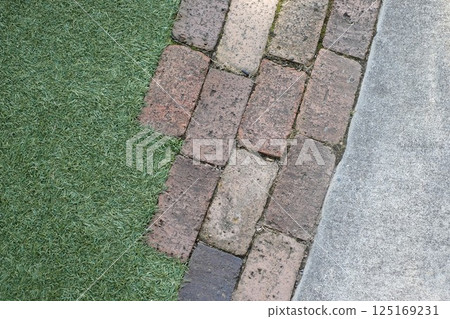 Bricks, artificial turf and concrete Bricks, artificial turf and concrete 125169231