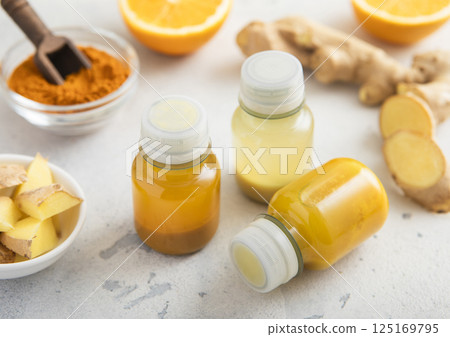 Immune ginger and turmeric energy shot drink with ginger root and turmeric powder Immune ginger and turmeric energy shot drink with ginger root and turmeric powder 125169795