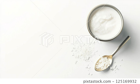 Fresh coconut milk in a can with shredded coconut garnish for culinary inspiration. 125169932
