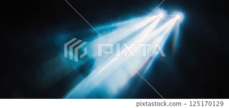 Bright beams of light cut through smoke, creating a dramatic and focused atmosphere. 125170129