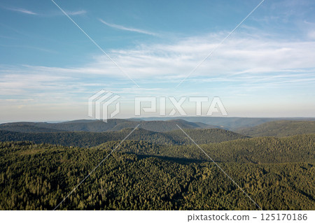 Aerial view of the Black Forest mountains under a blue sky Aerial view of the Black Forest mountains under a blue sky 125170186