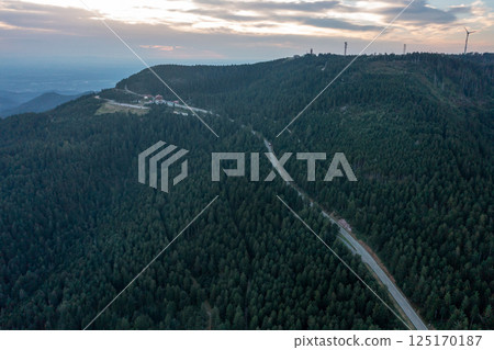 Aerial view of winding road going through the Black Forest at sunset 125170187