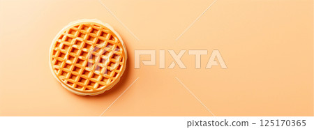A round Belgian waffle with a golden-brown texture, placed against a clean background with copy space for text. Perfect for food banners, breakfast promotions 125170365