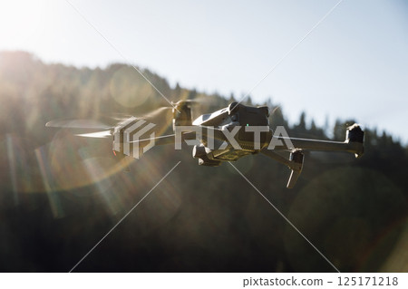Drone flying in sunrise high altitude mountains 125171218