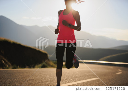 Fitness woman runner running in sunrise mountain road Fitness woman runner running in sunrise mountain road 125171220