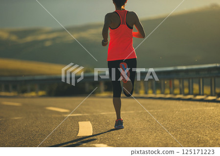 Fitness woman runner running in sunrise mountain road Fitness woman runner running in sunrise mountain road 125171223