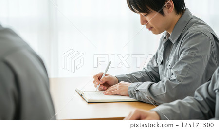 Asian man in work clothes receiving training Asian man in work clothes receiving training 125171300