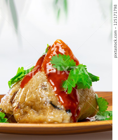 Delicious rice dumplings with sauce and coriander 125171798