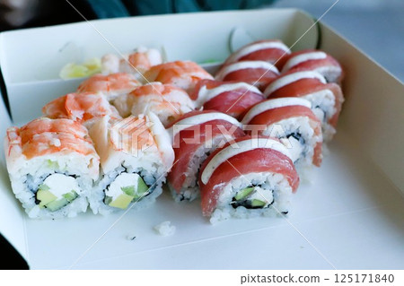 Indulge in the Most Delicious Sushi Rolls Presented Perfectly in a Takeout Box for You 125171840