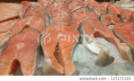 Fresh Salmon Fillets Positioned on Ice to Create Culinary Delights and Experiences Fresh Salmon Fillets Positioned on Ice to Create Culinary Delights and Experiences 125172103
