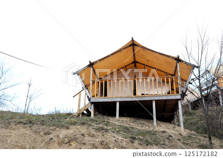 Charming Elevated Glamping Tent Cabin Nestled on a Beautiful Hill Surrounded by Nature 125172182