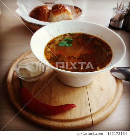 Experience a Delicious and Flavorful Soup Made with Fresh Ingredients and Soft Bread Rolls Experience a Delicious and Flavorful Soup Made with Fresh Ingredients and Soft Bread Rolls 125172184