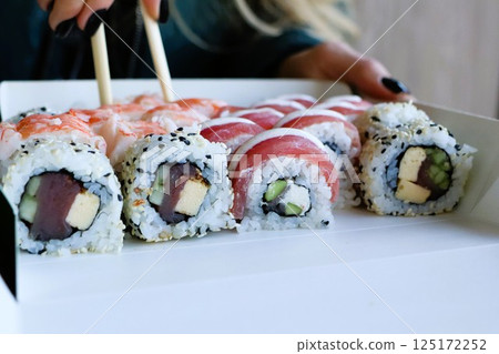 Enjoy the mouthwatering and delicious sushi rolls that are beautifully served on a platter 125172252