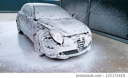A Car Being Covered in a Layer of Foam for Enhanced Cleaning and Detailing Process 125172429