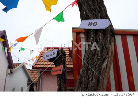 Whimsical Directional Signs Positioned in a Colorful and Engaging Outdoor Setting for Everyone Whimsical Directional Signs Positioned in a Colorful and Engaging Outdoor Setting for Everyone 125172564