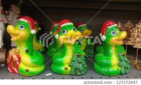 Charming and Festive Green snake Decor Complete with Delightful Santa Hats for the Holidays 125172647