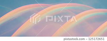 Tiny rainbows in varied colors gently arc across a soft background, perfect for decorations. 125172651