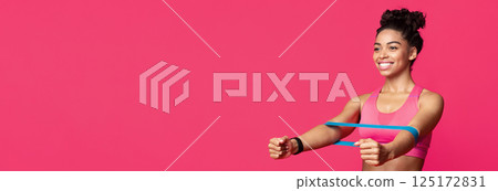 Sporty smiling black woman doing stretching work out with elastic bands, squating over red studio background, panorama with copy space Sporty smiling black woman doing stretching work out with elastic bands, squating over red studio background, panorama with copy space 125172831