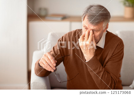 Eyes Fatigue. Senior Man Massaging Nosebridge Sitting On Sofa At Home. Selective Focus, Free Space 125173068