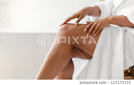 Side View Of Unrecognizable Black Lady Touching Perfect Smooth Legs After Depilation Posing Sitting On Chair In Bathroom At Home. Cropped Shot Of Female Legs. Hair Removal And Body Care Side View Of Unrecognizable Black Lady Touching Perfect Smooth Legs After Depilation Posing Sitting On Chair In Bathroom At Home. Cropped Shot Of Female Legs. Hair Removal And Body Care 125173155
