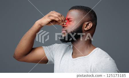 Overworked afro man touching his nose bridge, suffering from eye pain, tired eyes Overworked afro man touching his nose bridge, suffering from eye pain, tired eyes 125173185