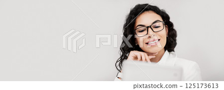 Successful Manager. Headshot of smiling mexican businesswoman using digital tablet at work, copyspace Successful Manager. Headshot of smiling mexican businesswoman using digital tablet at work, copyspace 125173613