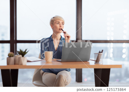 Pensive Businesswoman At Laptop Thinking On A Task Working In Modern Office. Business Lifestyle. Selective Focus Pensive Businesswoman At Laptop Thinking On A Task Working In Modern Office. Business Lifestyle. Selective Focus 125173864