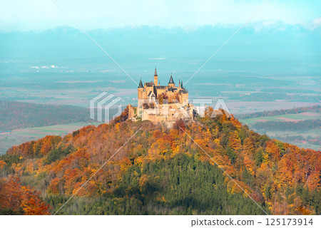 Autumn landscape with Hohenzollern castle surrounded by a colorful forest Autumn landscape with Hohenzollern castle surrounded by a colorful forest 125173914