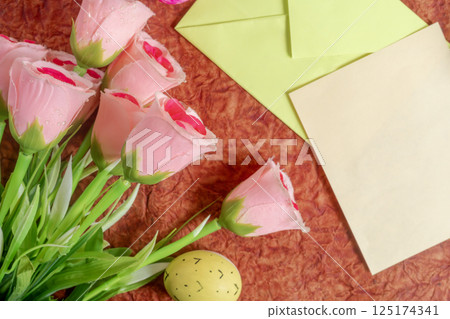 Beautiful pink roses and blank stationery on a textured background. 125174341