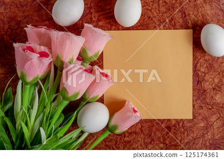 Pink roses and Easter eggs on a textured background with empty space. Happy Easter Pink roses and Easter eggs on a textured background with empty space. Happy Easter 125174361