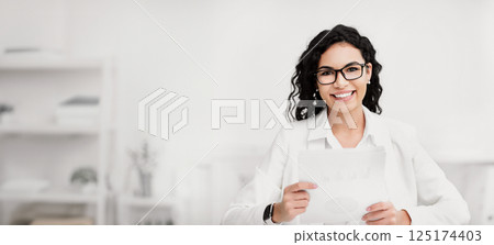 Job Interview. Mexican HR manager recruiting employees, holding documents, smiling at camera. Free space Job Interview. Mexican HR manager recruiting employees, holding documents, smiling at camera. Free space 125174403