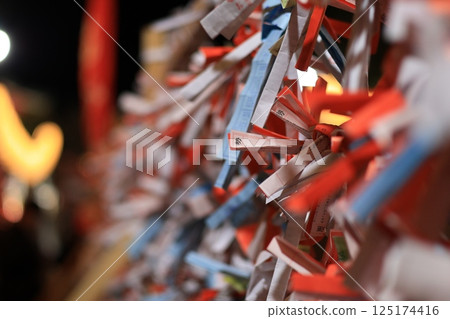 A close-up of fortune slips tied in the grounds of Enoshima Shrine A close-up of fortune slips tied in the grounds of Enoshima Shrine 125174416