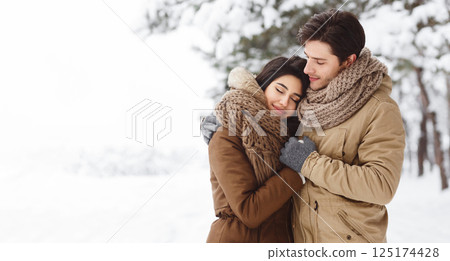 Winter Love. Cute Lovers Embracing Standing In Snowy Forest Having Date Outdoor. Copy Space, Panorama 125174428
