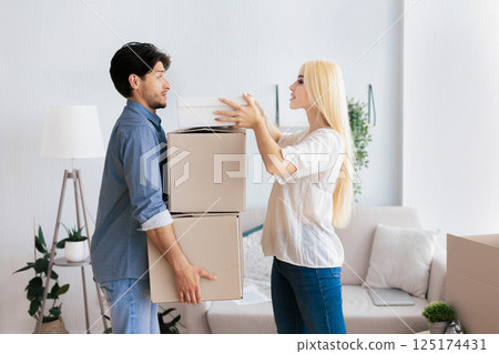 Moving Apartment Preparation. Young Couple Carrying Out Packed Boxes With Their Stuff From Old Flat. Empty Space 125174431
