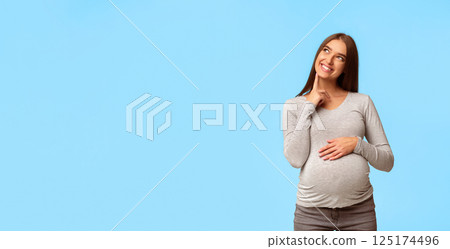 Dream. Happy Pregnant Woman Thinking Imagining Motherhood Life Standing Over Gray Studio Background. Copy Space 125174496
